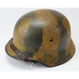 German Nazi Helmet with liner, chin strap and camo paint which covers single decal. Helmet rim