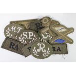 Cloth badges selection of WW2 trade badges and RA slip on epaulets.