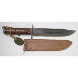 American M1 fighting knife, complete with contemporary replacement leather scabbard, has a WW2 era