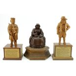 Three hand carved wooden figures, depicting interesting characters in history, each mounted on a