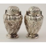Pair of Victorian ornate silver peppers with unusual locking system, hallmarked 'Sheffield, 1887'.