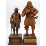 Two hand carved wooden figures, depicting interesting characters in history, each mounted on a