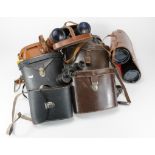 Binoculars. A collection of nine pairs of binoculars, mostly in original cases