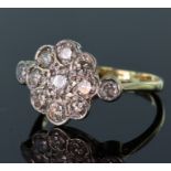 18ct yellow gold diamond cluster ring consisting of a central round brilliant cut diamond calculated