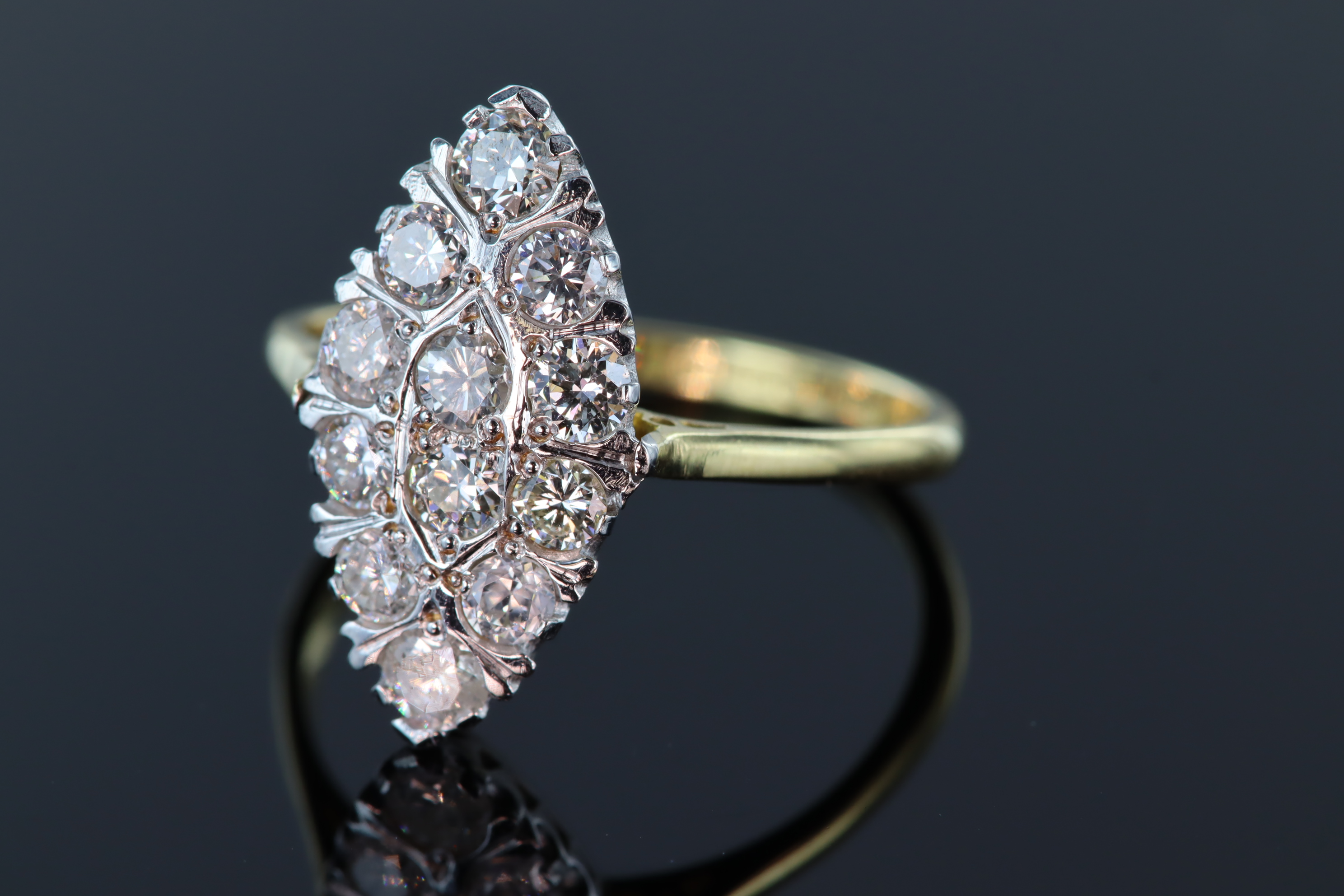 18ct and platinum marquise shaped diamond ring consisting of twelve round brilliant cut diamonds