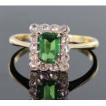18ct and platinum rectangular shaped ring set with central green stone surrounded by fourteen mine