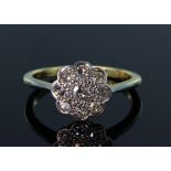 Daisy cluster ring comprising central round brilliant cut diamond surrounded by a further eight