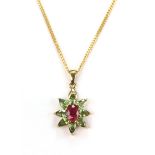 9ct yellow gold pendant set with central oval ruby measuring 7mm x 5mm, surrounded by eight pear