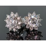 18ct white gold cluster stud earrings consisting of a centre round brilliant cut diamond weighing
