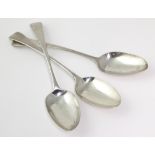 Three George III silver old English pattern table spoons (including a matching pair), each with