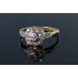 18ct yellow and white gold ring consisting of a central round brilliant cut diamond surrounded by