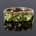 9ct yellow gold trilogy ring set with three 6mm round peridot stones totalling 2.366ct, finger