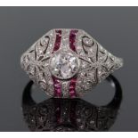 Platinum diamond and ruby Art Deco style bombe shaped ring set with a central round brilliant cut