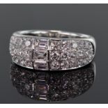 18ct white gold diamond set band ring comprising a centre section set with three emerald cut