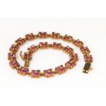 9ct yellow gold tennis bracelet consisting of twenty two links of clusters of four almandine