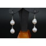 14ct white gold drop earrings set with two baroque shaped cultured freshwater pearls per earring, on