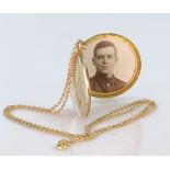 Yellow metal phot locket (with two old photos inside) on a 9ct chain, total weight 7.8g