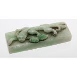 Jade scroll weight, circa early 20th Century depicting a dragon, length 85mm approx.