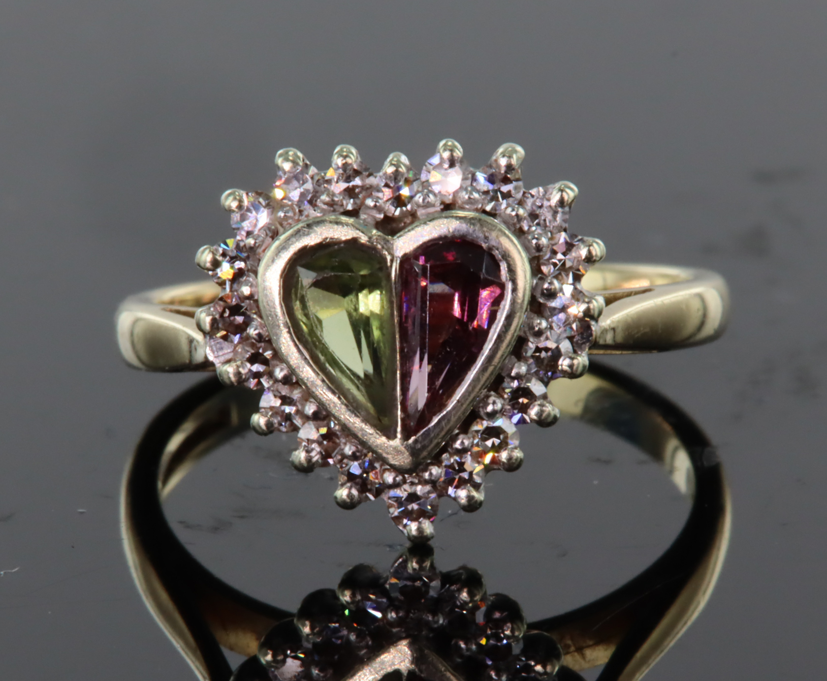 9ct yellow and white gold heart shaped ring set with a pink and green calibre cut tourmaline