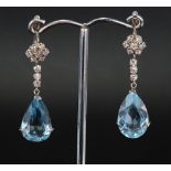 18ct white gold drop earrings set with a pear shaped aquamarine measuring approx. 16mm x 10mm,