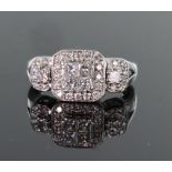 14ct white gold cluster ring consisting of a central group of four 3mm princess cut diamonds