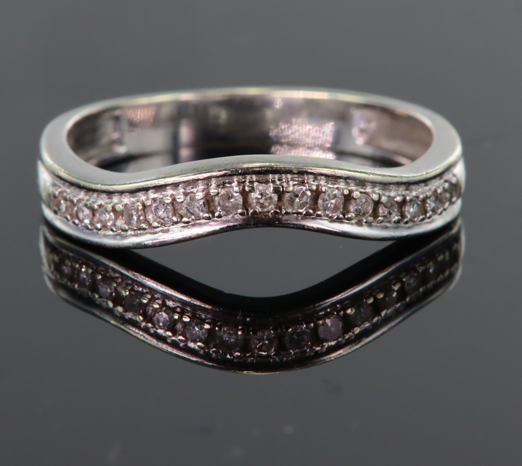 9ct white gold shaped band ring set with fifteen round diamonds in a millegrain setting, total