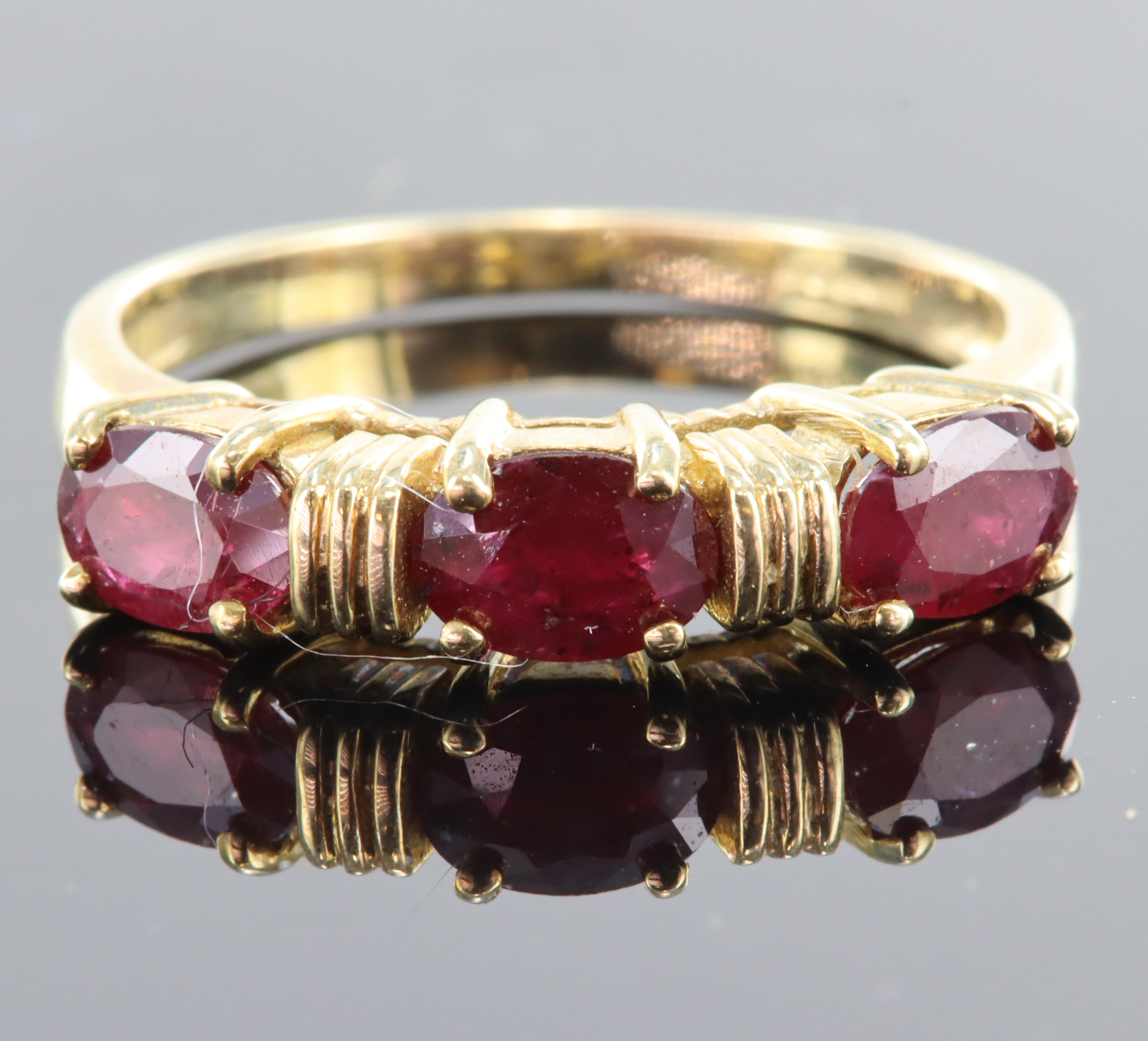 9ct yellow gold ring set with three 6mm x 4mm oval rubies totalling 1.26ct, finger size N, weight