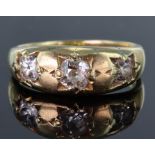 Tests as 15ct yellow gold gypsy set three stone ring set with three old cut diamonds, centre diamond