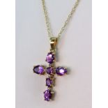 9ct yellow gold cross pendant measuring 28mm x 16mm, set with oval and round amethysts with