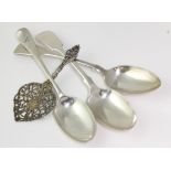 Three Sheffield hallmarked silver table spoons & a silver strainer (?), two table spoons with