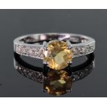 9ct white gold ring set with a round 7mm citrine bordered on each shoulder by four round 1.7mm