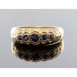 9ct yellow gold flared head band ring set with five graduated sapphires, finger size R-S, weight 3.