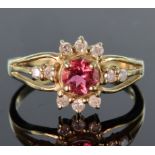 9ct yellow gold ring set with a round 5mm pink tourmaline bordered top and bottom by three round 1.