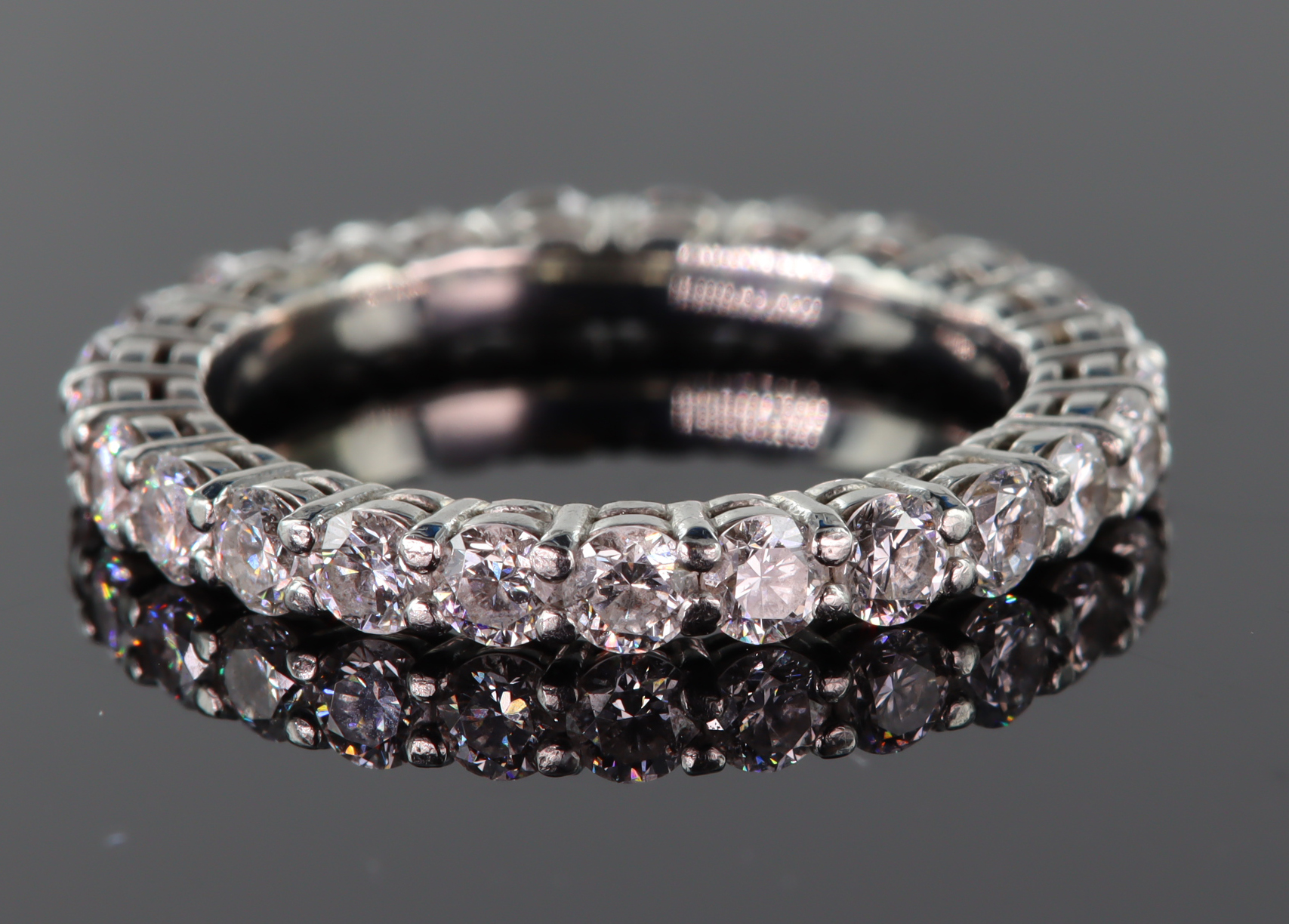 Tests as 18ct white gold diamond full eternity ring set with twenty five round brilliant cut