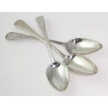 Three George III silver old English pattern table spoons, two handles ornately decorated, hallmarked