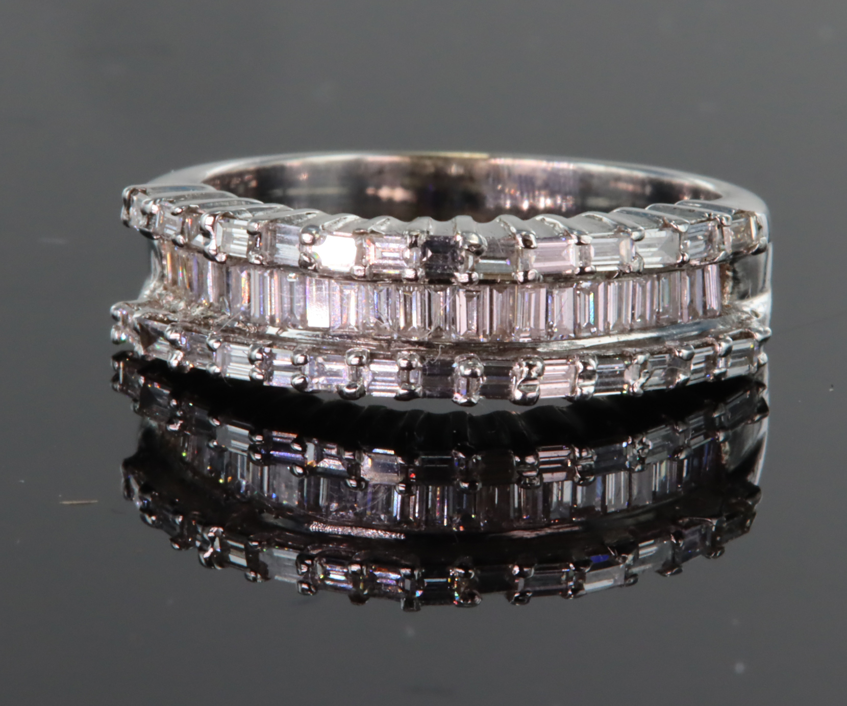 18ct white gold three row diamond ring consisting of central channel set recessed row of baguette