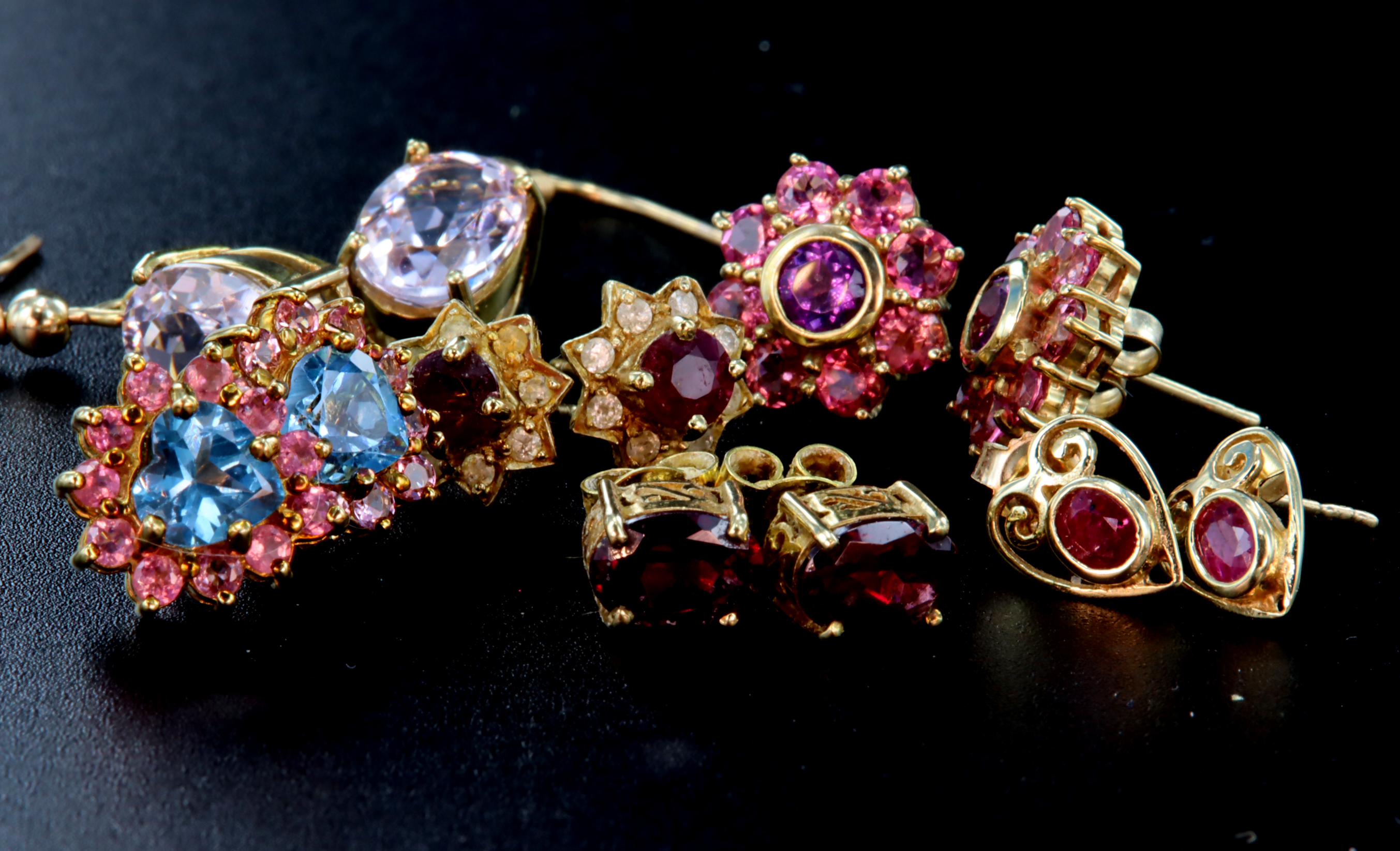 Six pairs of earrings to include a 9ct pair of oval rubies set in a heart shaped open mount with