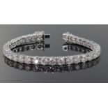 18ct white gold tennis bracelet comprising thirty four round brilliant cut diamonds with a total