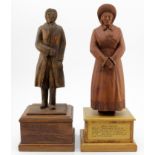 Two hand carved wooden figures, depicting interesting characters in history, each mounted on a