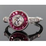 Platinum diamond and ruby ring consisting of central round brilliant cut diamond calculated as
