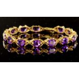 9ct yellow gold tennis style bracelet consisting of fourteen oval 8mm x 6mm Uruguayan amethysts