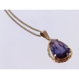 9ct Gold Teardrop Pendant with a purple stone on a 16 inch fine chain weight 6.3g