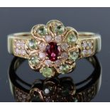9ct yellow gold cluster ring consisting of central oval 4mm x 3mm ruby, surrounded by eight round