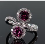 18ct white gold double cluster crossover design ring set with two round pink tourmaline measuring