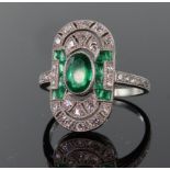Platinum emerald and diamond Art Deco style elongated oval ring comprising central oval emerald