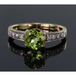 9ct yellow gold ring set with round 7mm peridot weighing 1.168ct in a four claw setting, bordered