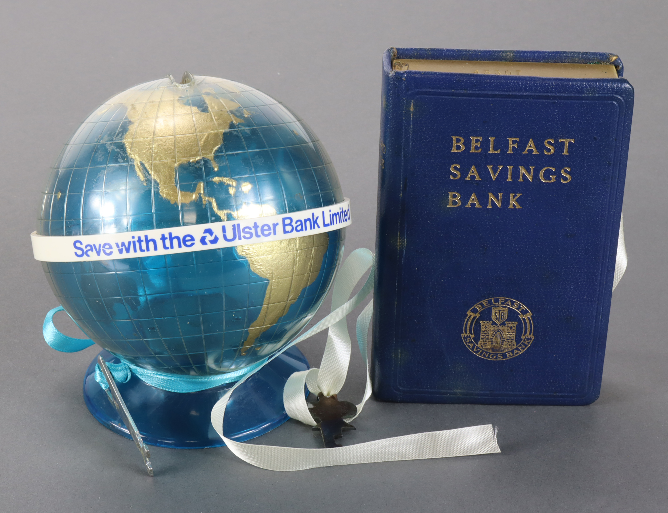 Money box (2), Belfast Savings Bank, book design no. 43307 with key, plus Ulster Bank Limited,