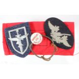 German Luftwaffe armband, Flak badge and unusual shield badge, plus a Luftwaffe marked bottle top