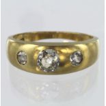 18ct yellow gold three stone band ring set with central round old cut diamond weighing approx. 0.