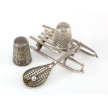 Silver sled, stamped '800' with thimble holder mount, length 60mm, together with a white metal